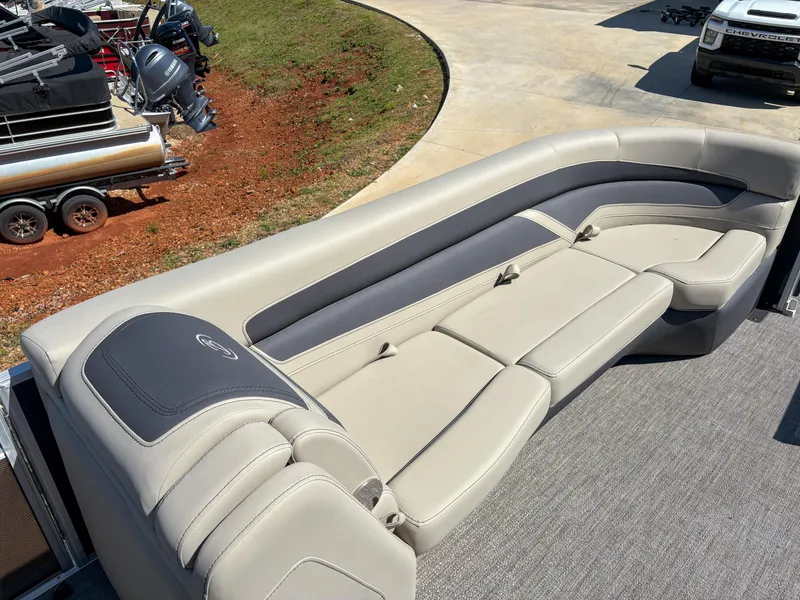 Slide: The Image of 2023 Barletta CABRIO 24 UC boat interior with beige seating and gray accents. - 12