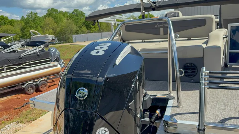 Slide: The Image of 2023 Barletta CABRIO 24 UC pontoon boat with powerful 200 HP engine, docked outdoors. - 15