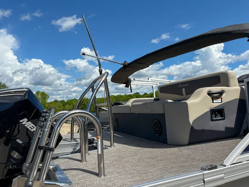 Slide: The Image of 2023 Barletta CABRIO 24 UC pontoon boat with seating, under a clear blue sky. - 16