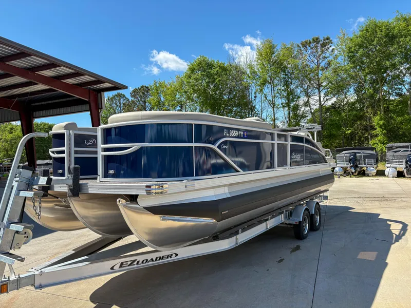 Slide: The Image of 2023 Barletta CABRIO 24 UC pontoon boat on trailer, parked outdoors. - 4