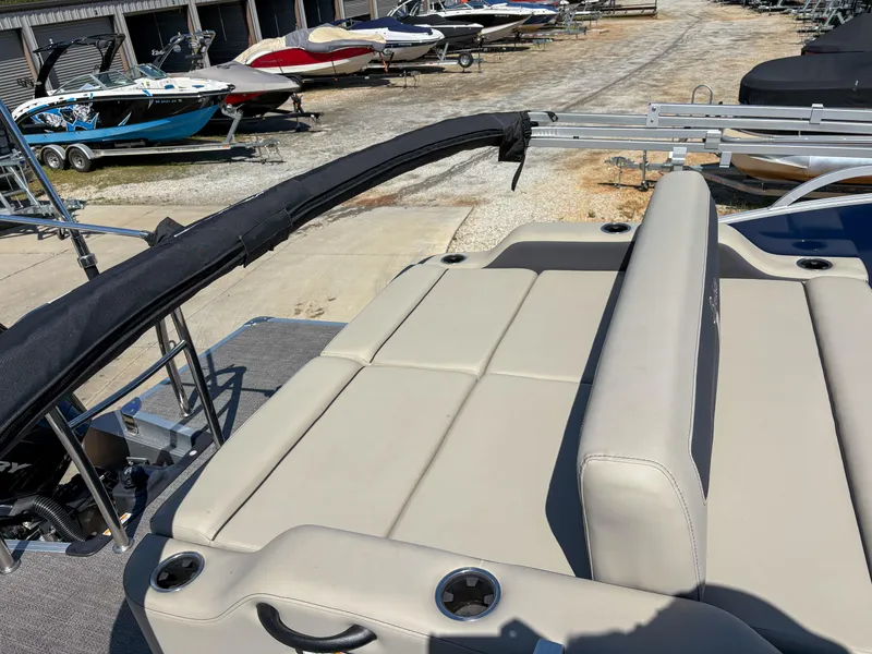 Slide: The Image of 2023 Barletta Cabrio 24 UC pontoon boat with beige seating in a marina. - 5