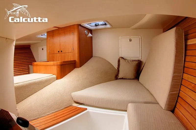 Slide: The Image of Cozy interior of 2008 Calcutta 390 boat with wooden accents and cushioned seating. - 13