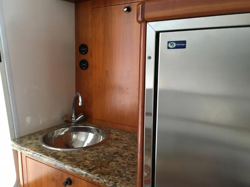 Slide: The Image of Kitchenette with stainless steel sink and fridge in 2008 Calcutta 390 boat. - 14