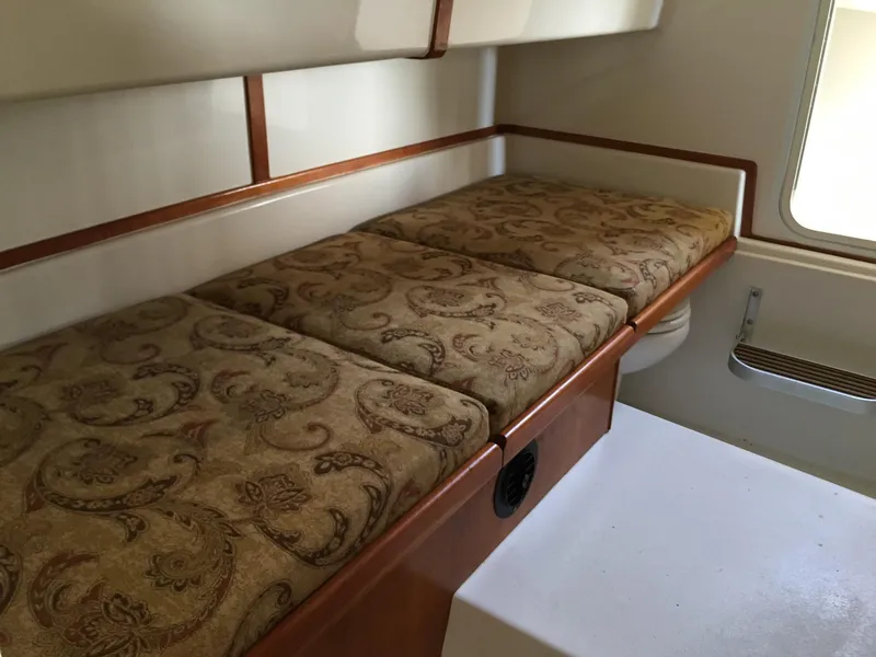 Slide: The Image of Interior of 2008 Calcutta 390 boat with patterned cushions and wooden accents. - 16