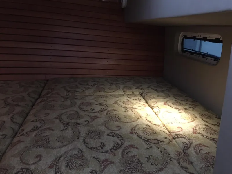 Slide: The Image of Cozy cabin interior of 2008 Calcutta 390 with patterned bedding and wooden paneling. - 20