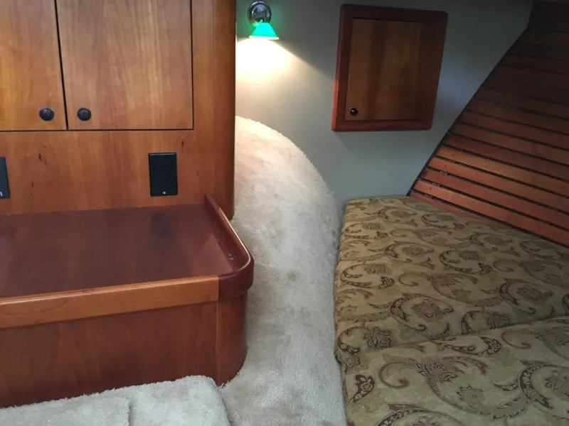 Slide: The Image of Interior of 2008 Calcutta 390 boat with wooden cabinetry and patterned upholstery. - 21