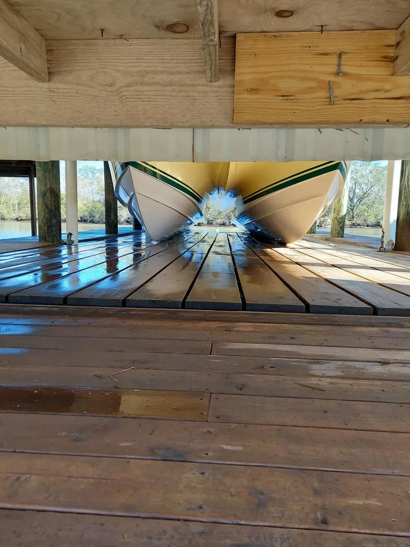 Slide: The Image of Calcutta 390 boat from 2008 on wooden dock, viewed from underneath. - 22