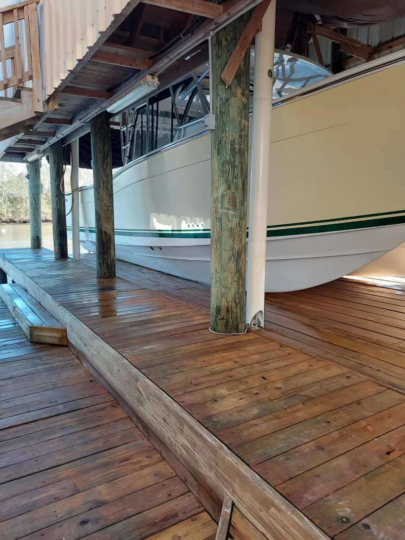 Slide: The Image of 2008 Calcutta 390 boat docked on wooden pier under shelter. - 23