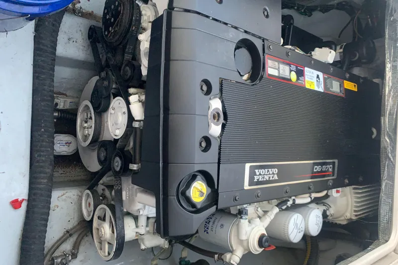 Slide: The Image of Volvo Penta engine in a 2008 Calcutta 390 boat, showcasing belts and components. - 25