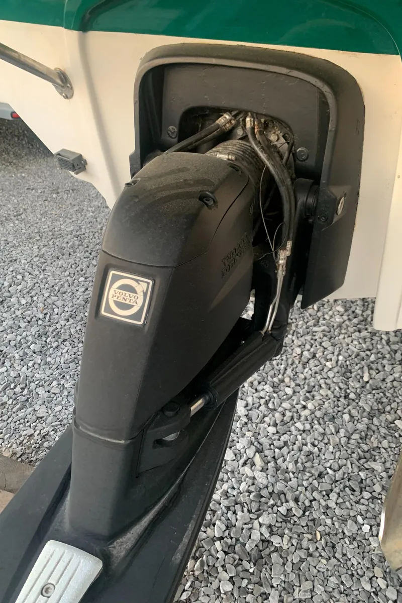 Slide: The Image of Outboard motor on a 2008 Calcutta 390 boat, displayed on gravel surface. - 26