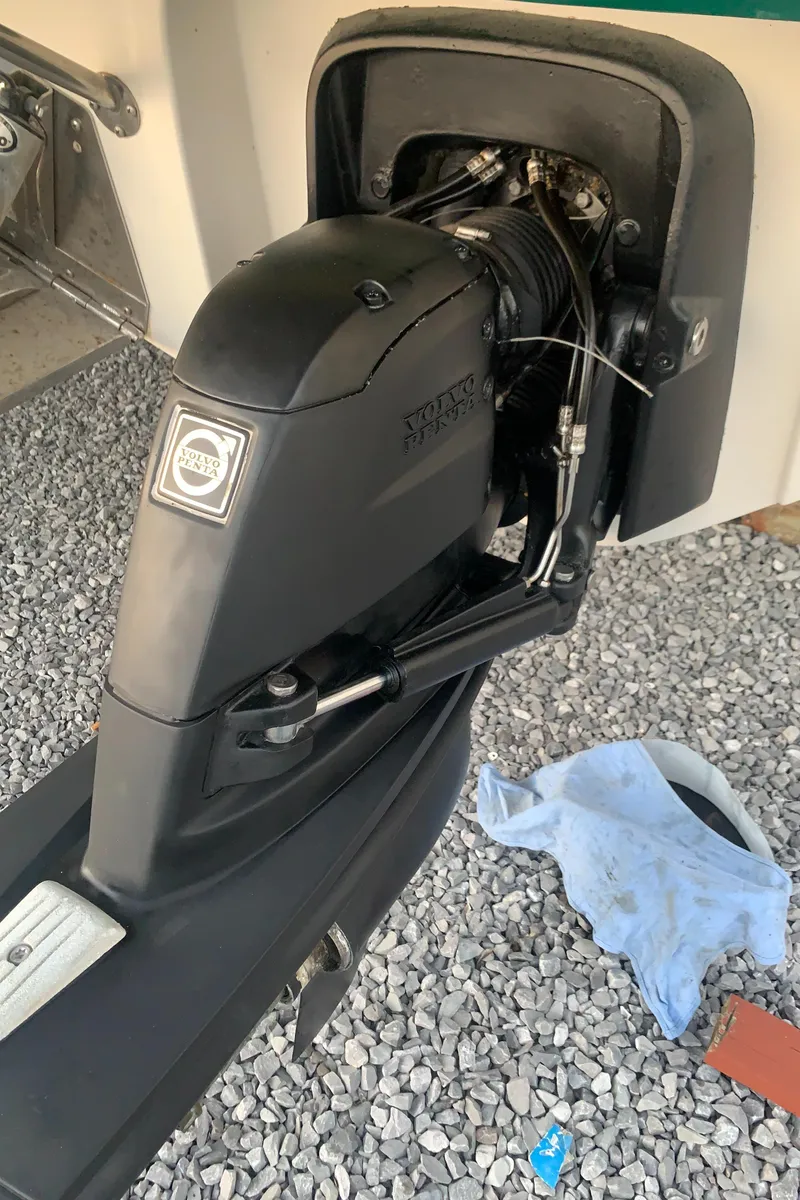 Slide: The Image of Calcutta 390 boat engine, 2008 model, on gravel surface with a cloth nearby. - 27