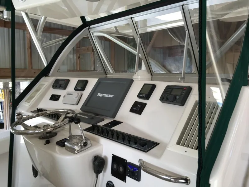Slide: The Image of 2008 Calcutta 390 boat dashboard with navigation controls and steering wheel. - 3