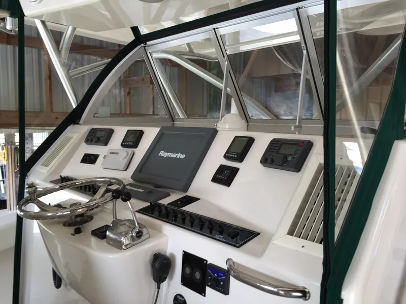 Slide: The Image of 2008 Calcutta 390 boat dashboard with navigation controls and Raymarine display. - 4