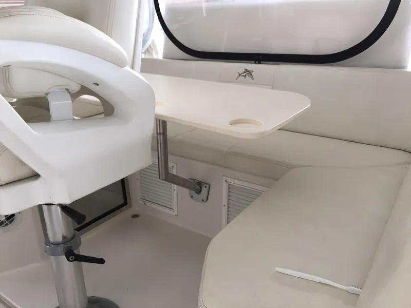 Slide: The Image of Interior of a 2008 Calcutta 390 boat with white seating and table. - 6