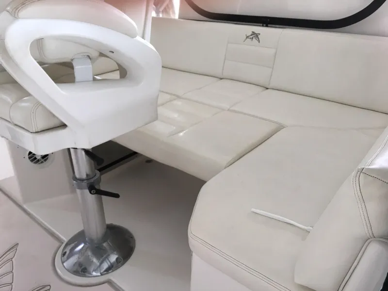 Slide: The Image of 2008 Calcutta 390 boat interior with white seating and adjustable captain's chair. - 7