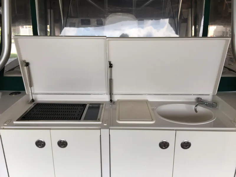 Slide: The Image of Outdoor kitchen setup on a 2008 Calcutta 390 boat with grill and sink. - 9