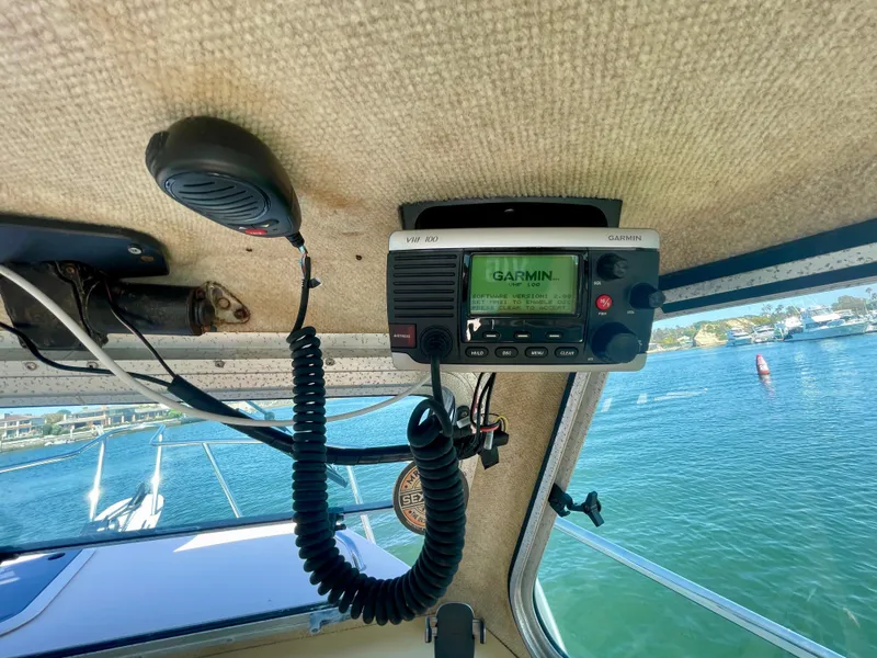 Slide: The Image of Boat interior with Garmin radio, Parker 2520 DV, 2008 model, overlooking water. - 14
