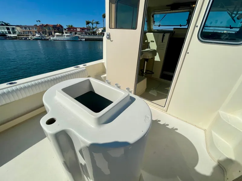 Slide: The Image of 2008 Parker 2520 DV boat interior with open deck and marina view. - 16