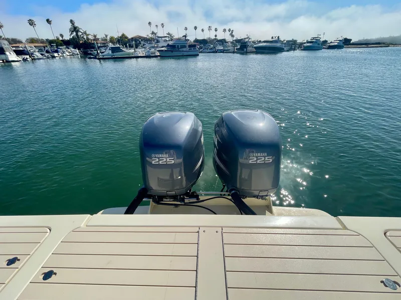 Slide: The Image of Twin Yamaha 225 engines on a 2008 Parker 2520 DV boat in a marina. - 18