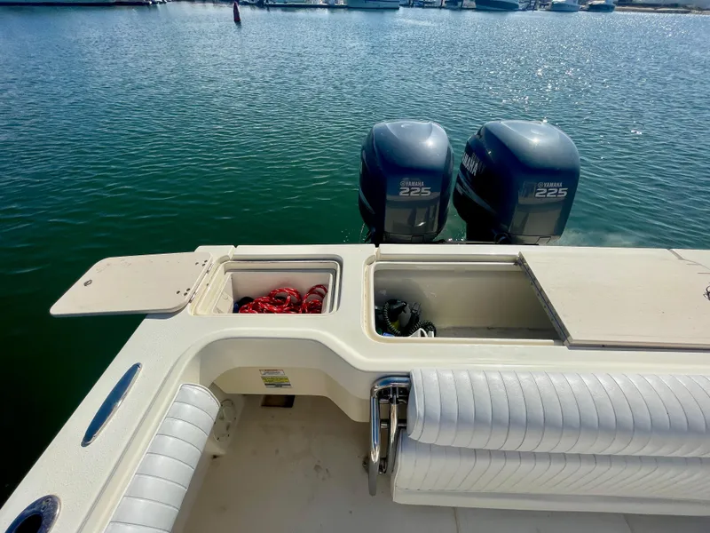 Slide: The Image of 2008 Parker 2520 DV boat with twin Yamaha 225 engines docked on calm water. - 22