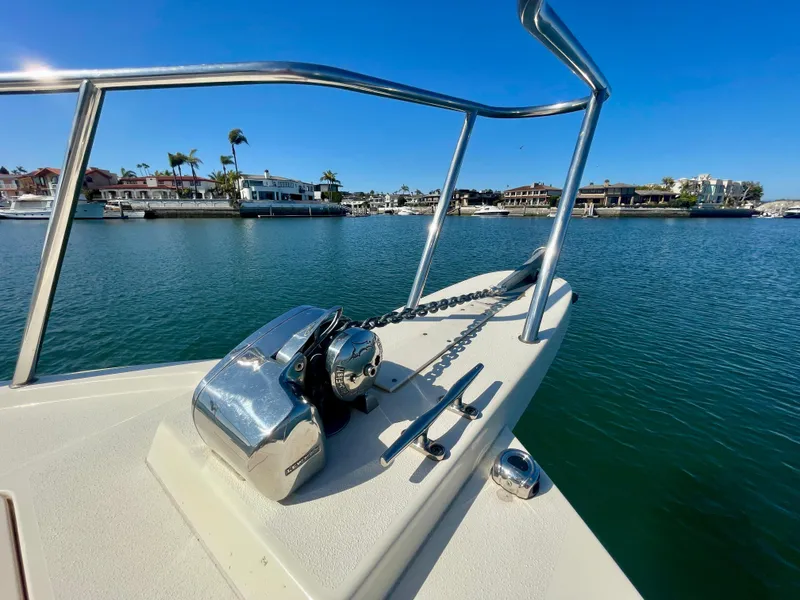 Slide: The Image of Bow of 2008 Parker 2520 DV boat with anchor chain, docked in a marina. - 23
