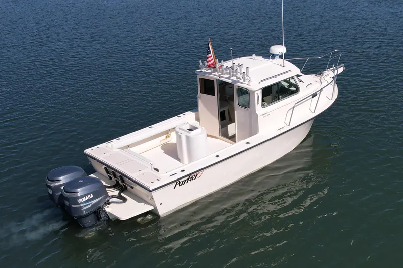 Slide: The Image of 2008 Parker 2520 DV boat with twin Yamaha engines on calm water. - 3