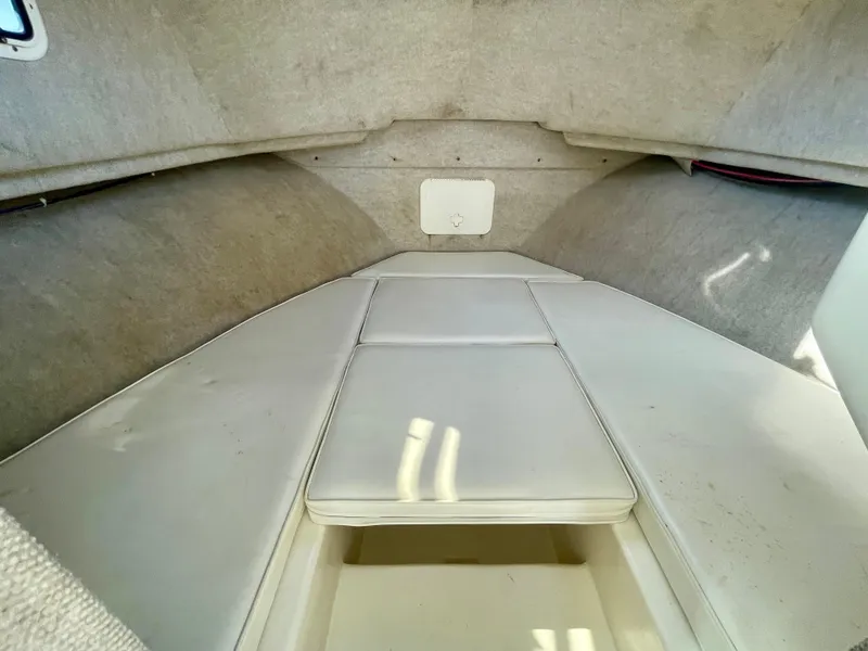 Slide: The Image of 2008 Parker 2520 DV boat interior cabin with cushioned seating and storage. - 6