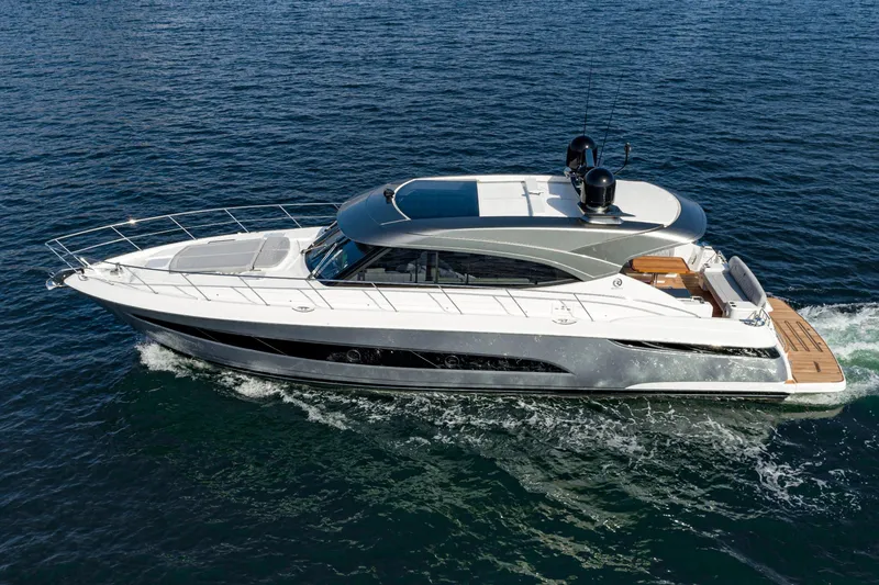 Slide: The Image of 2023 Riviera 5400 Sport Yacht cruising on open water. - 1