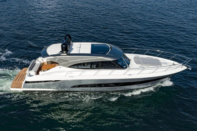 Slide: The Image of 2023 Riviera 5400 Sport Yacht cruising on open water, showcasing sleek design and luxury. - 10