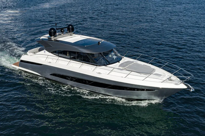 Slide: The Image of 2023 Riviera 5400 Sport Yacht cruising on open water, showcasing sleek design and luxury features. - 12