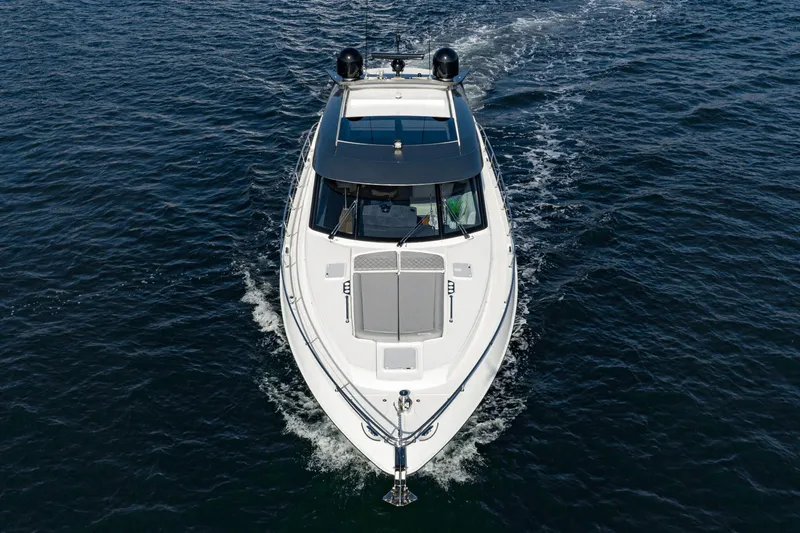 Slide: The Image of 2023 Riviera 5400 Sport Yacht cruising on open water, aerial view. - 13