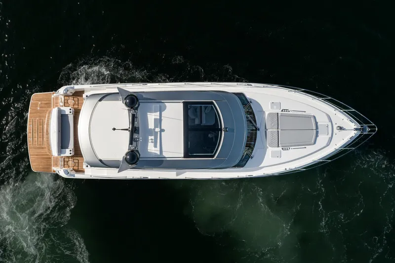 Slide: The Image of Aerial view of 2023 Riviera 5400 Sport Yacht cruising on dark water. - 14