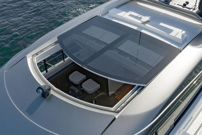 Slide: The Image of 2023 Riviera 5400 Sport Yacht with sunroof, aerial view, on water. - 18