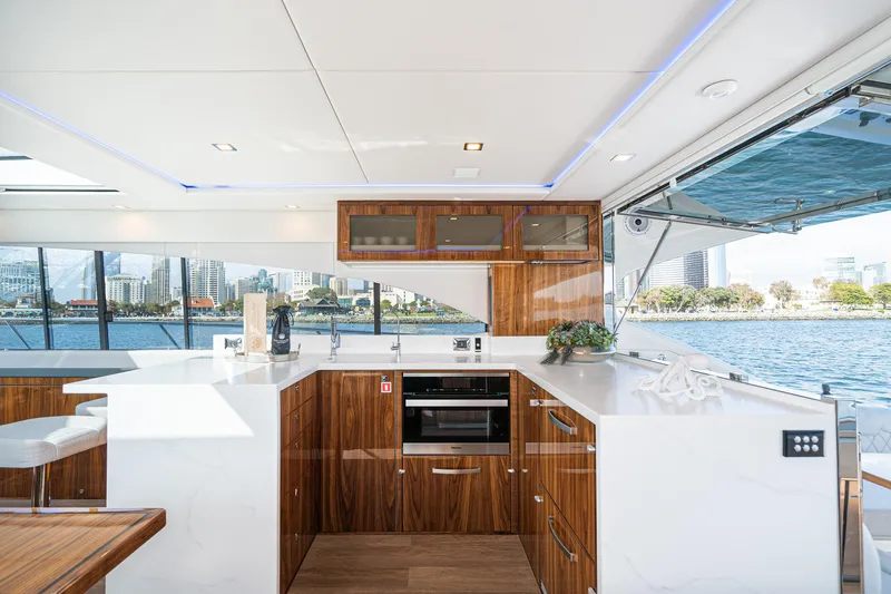 Slide: The Image of Luxurious interior of 2023 Riviera 5400 Sport Yacht with modern kitchen and waterfront view. - 27