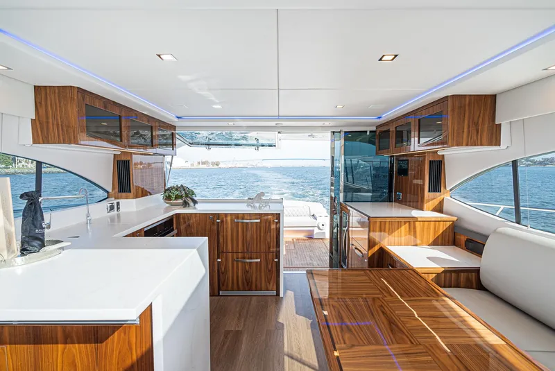 Slide: The Image of Luxurious interior of 2023 Riviera 5400 Sport Yacht with modern wood finishes and ocean view. - 28