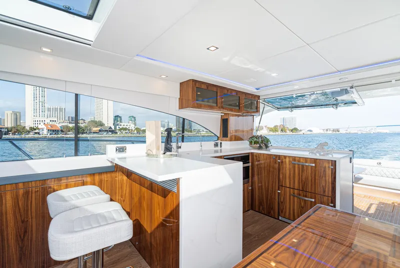 Slide: The Image of Luxurious interior of 2023 Riviera 5400 Sport Yacht with modern kitchen and waterfront view. - 29