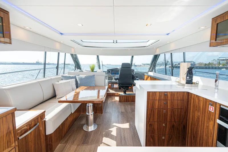 Slide: The Image of Luxurious interior of 2023 Riviera 5400 Sport Yacht with modern seating and panoramic windows. - 31