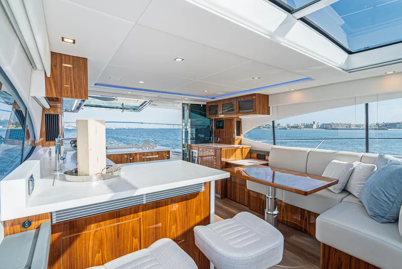 Slide: The Image of 2023 Riviera 5400 Sport Yacht interior with modern design, spacious seating, and ocean view. - 32
