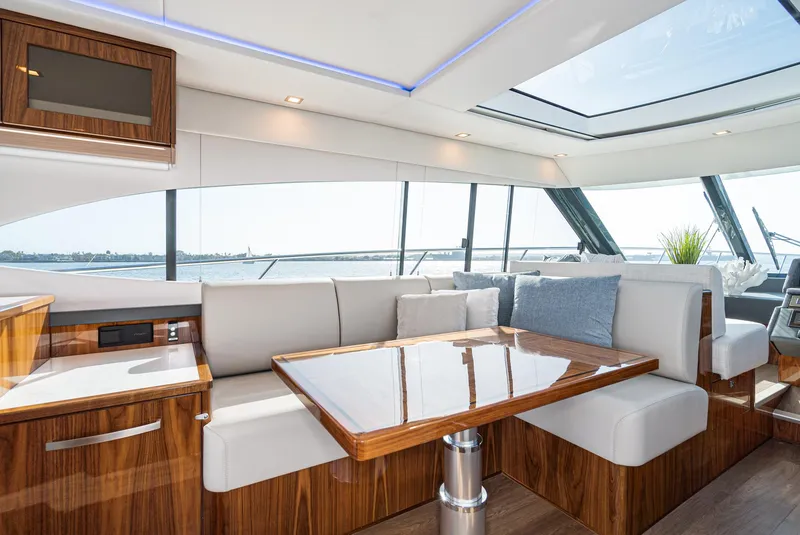 Slide: The Image of Luxurious interior of 2023 Riviera 5400 Sport Yacht with elegant seating and panoramic windows. - 33