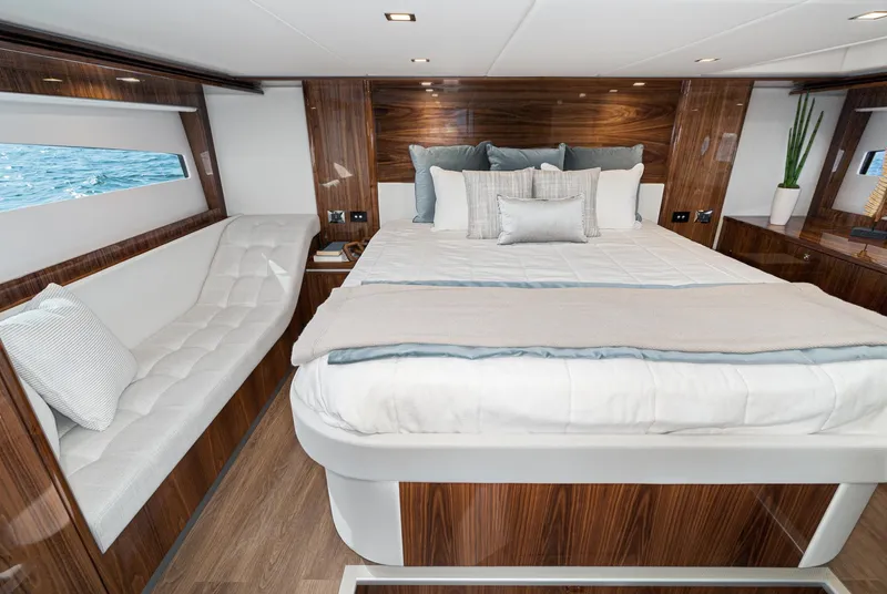 Slide: The Image of Luxurious bedroom interior of 2023 Riviera 5400 Sport Yacht with elegant wood finish. - 39