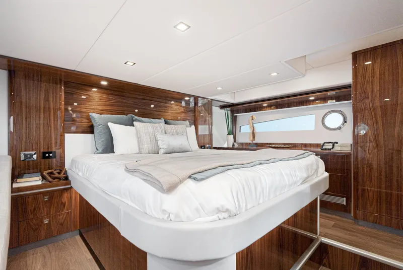 Slide: The Image of Luxurious bedroom interior of 2023 Riviera 5400 Sport Yacht with elegant wood finishes. - 40