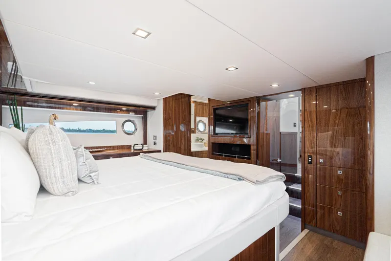 Slide: The Image of Luxurious bedroom interior of 2023 Riviera 5400 Sport Yacht with elegant wood finishes. - 41