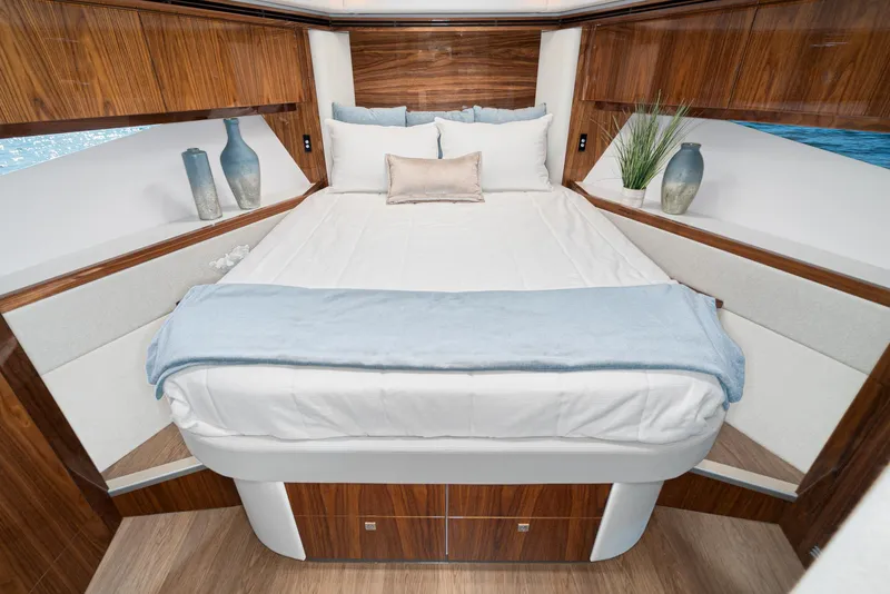 Slide: The Image of Luxurious bedroom interior of 2023 Riviera 5400 Sport Yacht with elegant wood finish. - 44