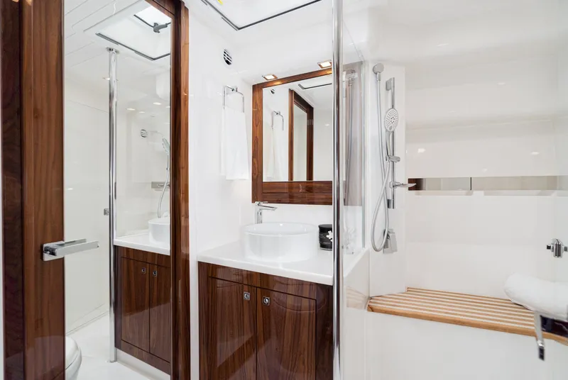 Slide: The Image of Luxurious bathroom in 2023 Riviera 5400 Sport Yacht with modern fixtures and wooden accents. - 48