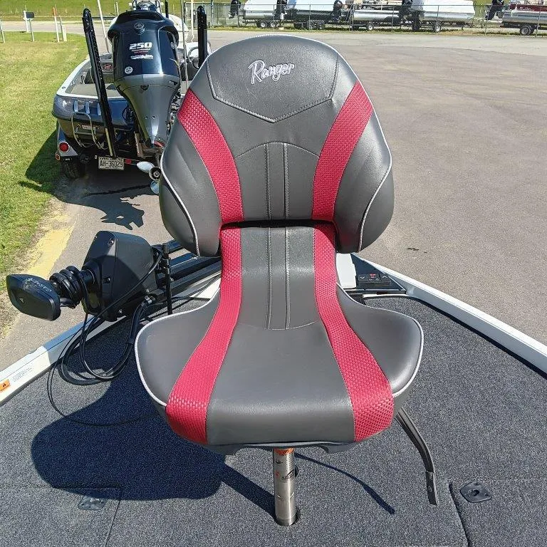 Slide: The Image of 2025 Ranger Z520 boat seat with red and gray design, parked on pavement. - 12