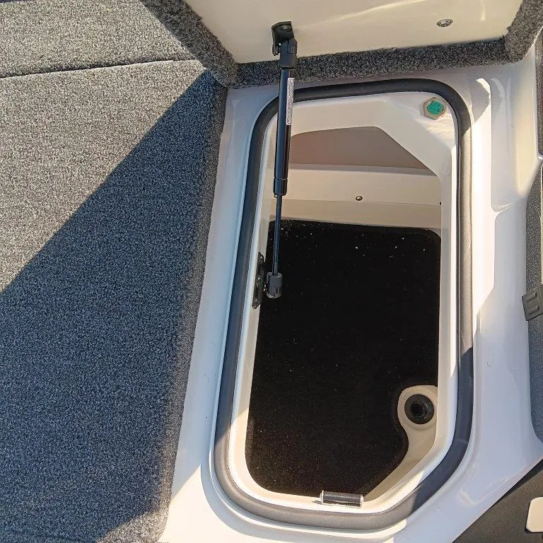 Slide: The Image of 2025 Ranger Z520 boat storage compartment with open hatch and hydraulic lift. - 6