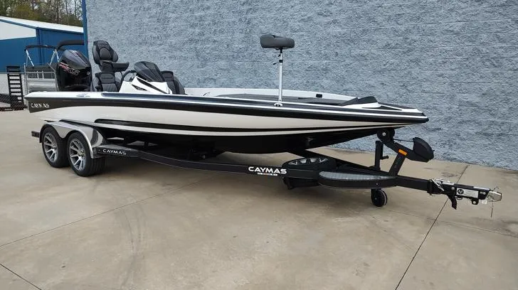 Slide: The Image of 2025 Caymas CX21 Pro boat on trailer, sleek design, parked outdoors. - 10