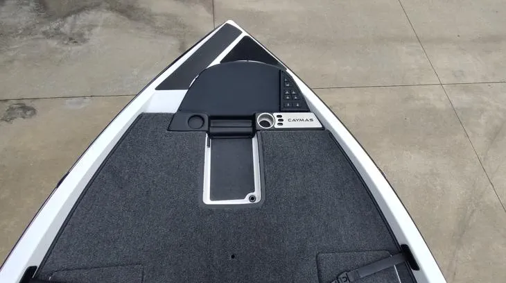 Slide: The Image of 2025 Caymas CX21 Pro boat deck with control panel and carpeted surface. - 2