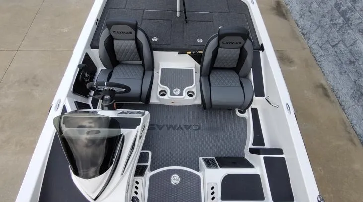 Slide: The Image of 2025 Caymas CX21 Pro boat interior with dual seats and steering console. - 4