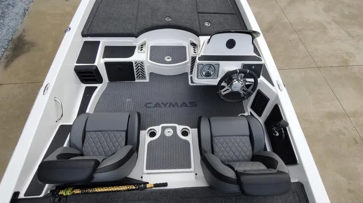 Slide: The Image of 2025 Caymas CX21 Pro boat interior with dual seats and steering console. - 5